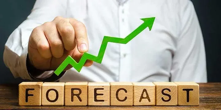 FORECAST wooden blocks with a person holding a green upward arrow